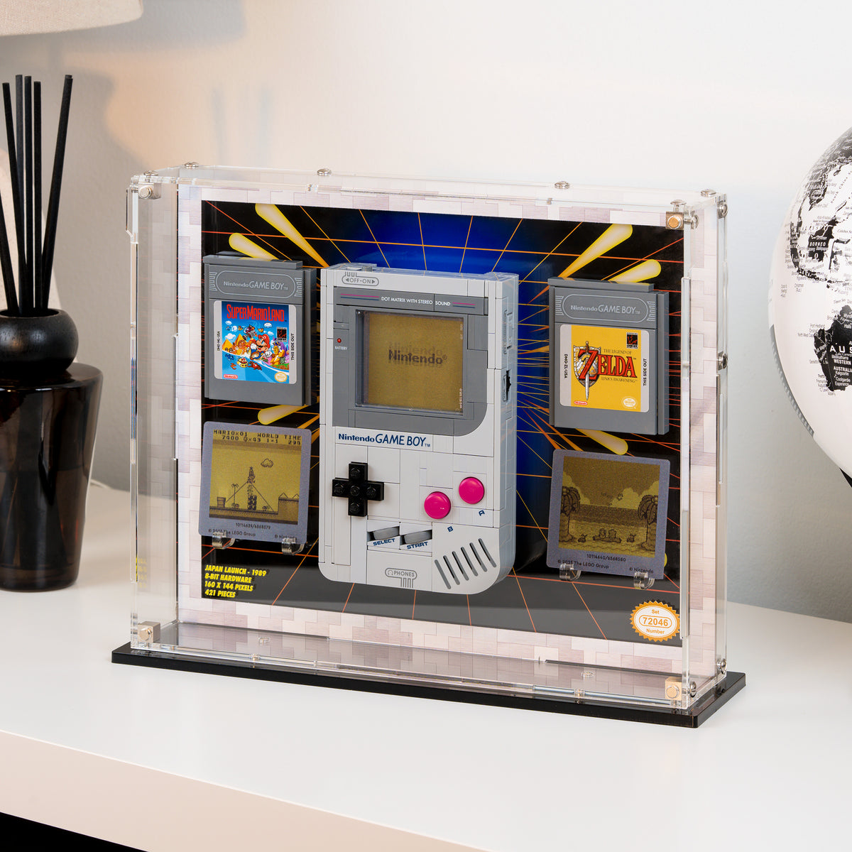 The Game Boy display case on its stand, seen from an angle on a white sideboard