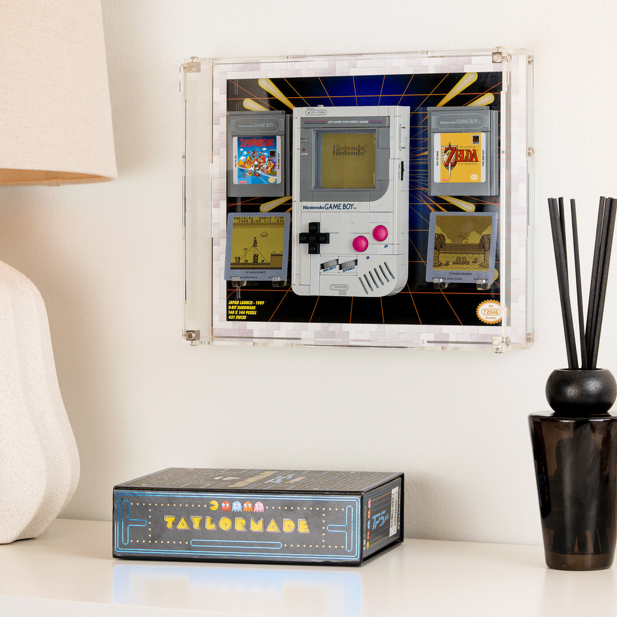 The Game Boy display case mounted on a wall above a sideboard