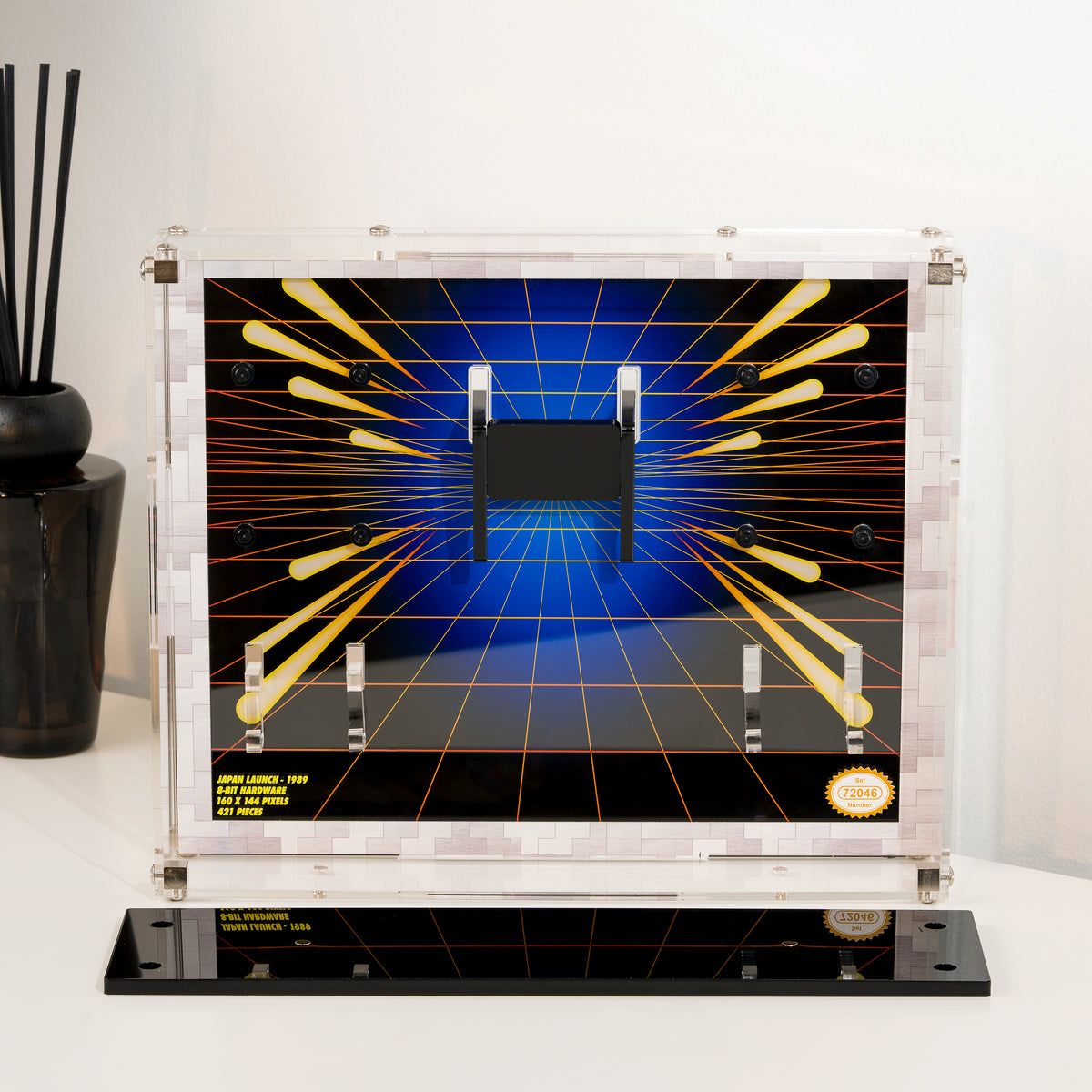 The empty display case on its stand, showing the printed retro grid background and the clear hooks