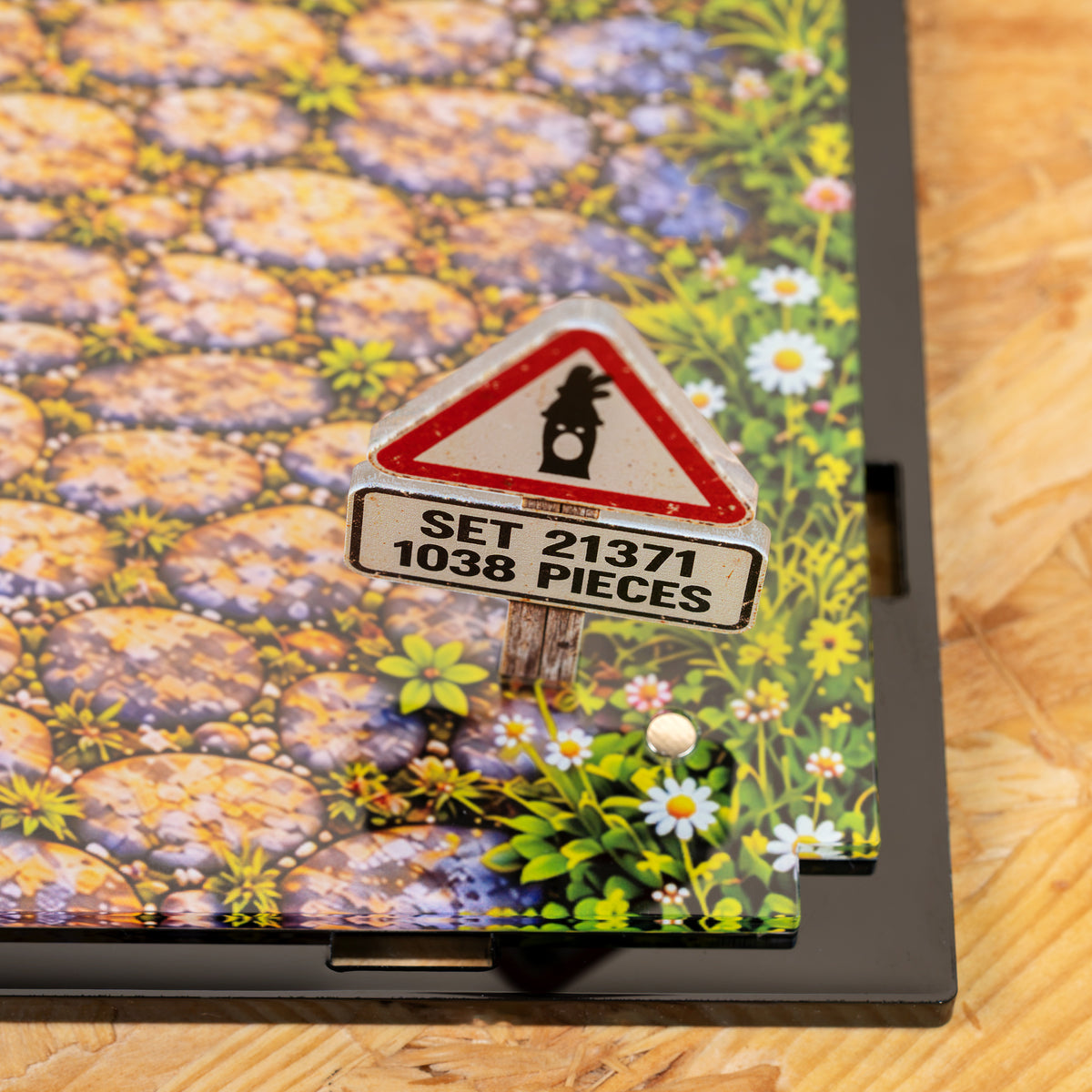 Close view of the printed cobbled road base with wild flowers and the set sign
